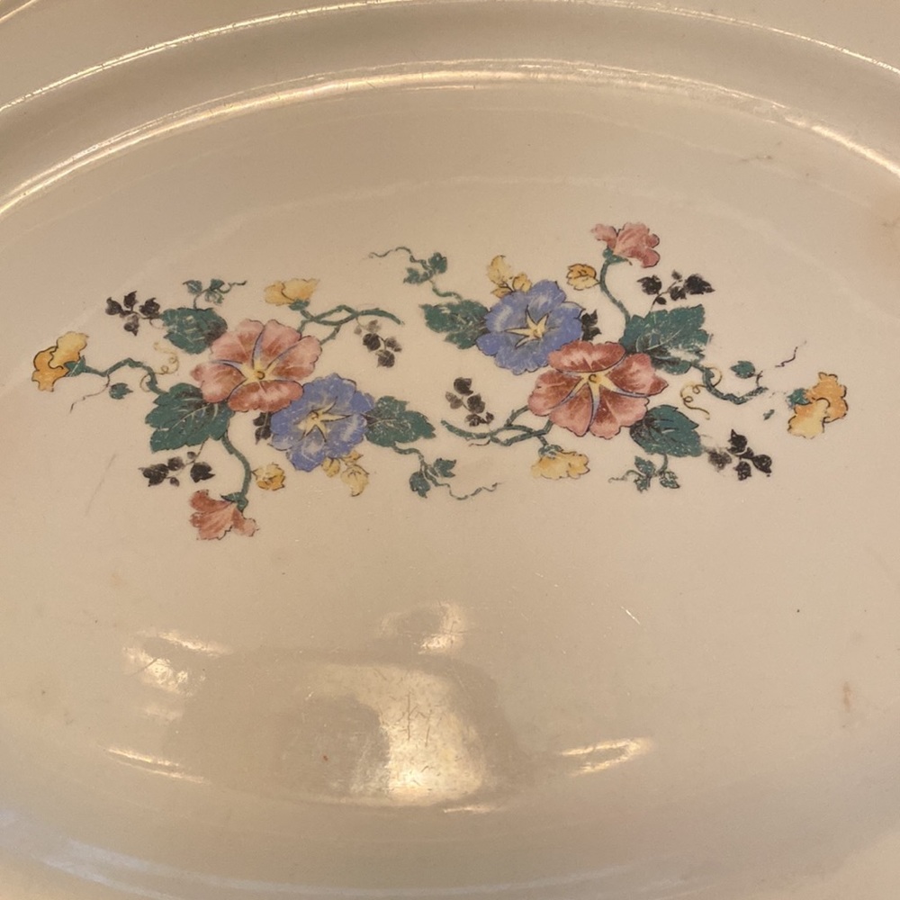 Antique oval serving platter. Scalloped edges with floral center Used condition